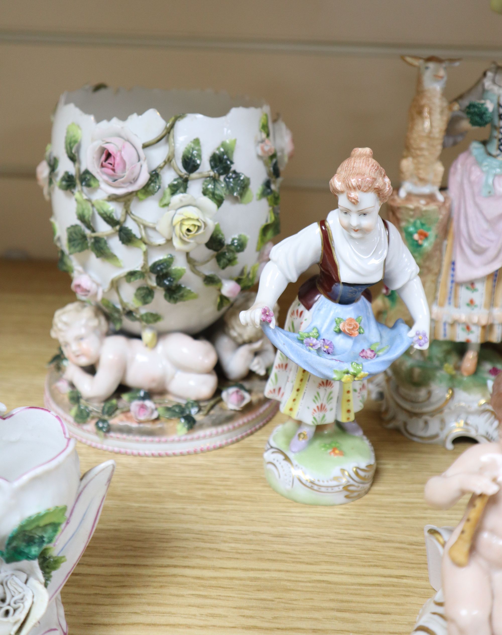 A Sitzendorf flower-encrusted egg-shaped porcelain vase with cherub supports and six other items,